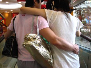 boyfriends holding purses